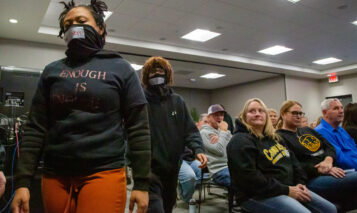 Shawnee Mission East students walk out of Monday's board meeting.